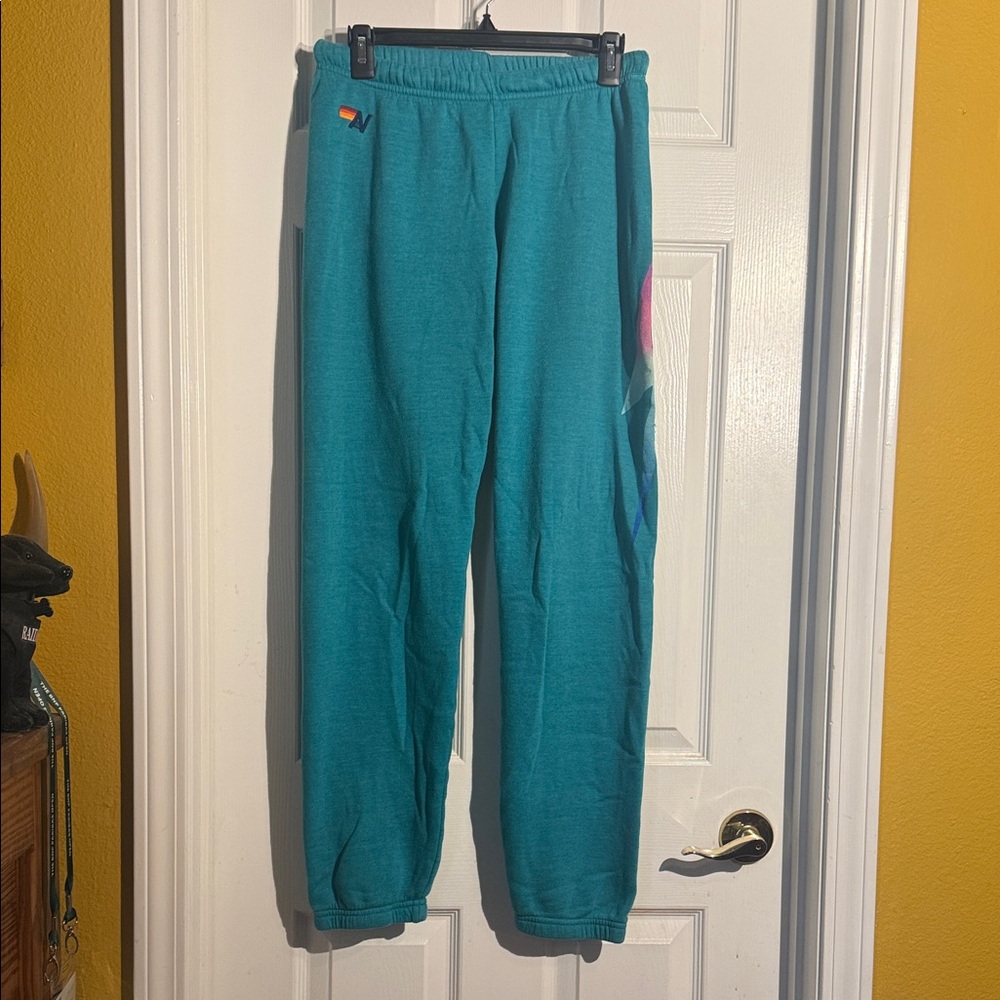 Aviator Nation Teal Sweatpants with Rainbow Lightning Bolt Detail